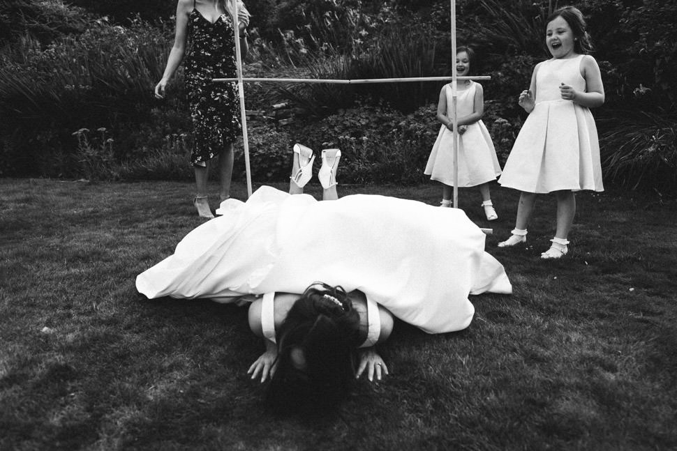 Fun bride falling doing limbo at wedding at The Falcondale Lampeter West Wales wedding photographer