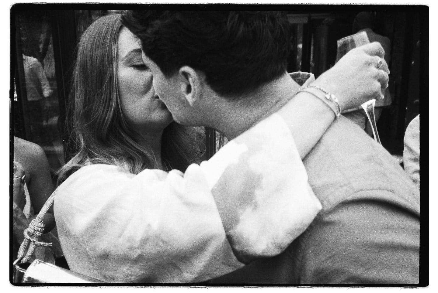 Wedding guest lovers on black and white analogue film